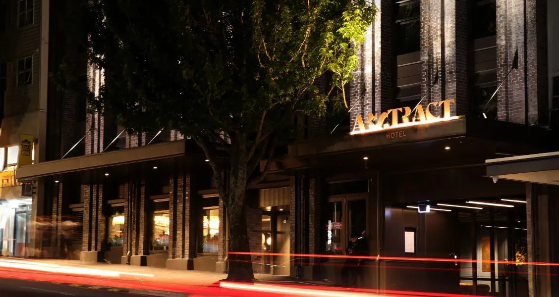Abstract Hotel's lit entrance signage on Karangahape Road at night